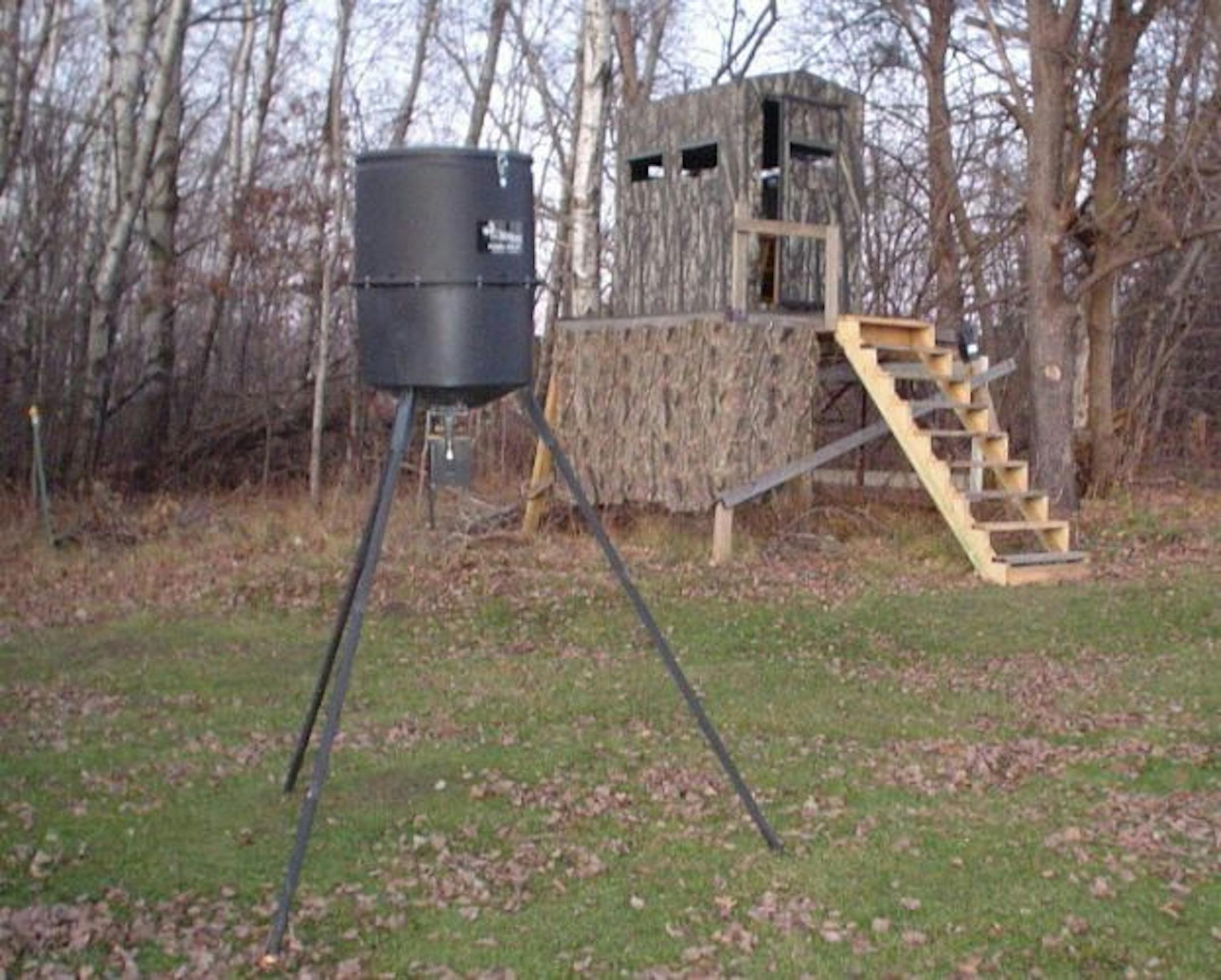 State conservation officials have noted a marked increase in citations for deer baiting the past several years, and the trend is continuing this fall. A woman aiming to help her 12-year-old grandson get a deer set up a mechanical feeder, above. DNR conservation officer Travis Muyres of Anoka said the woman was cited and her gun was seized.