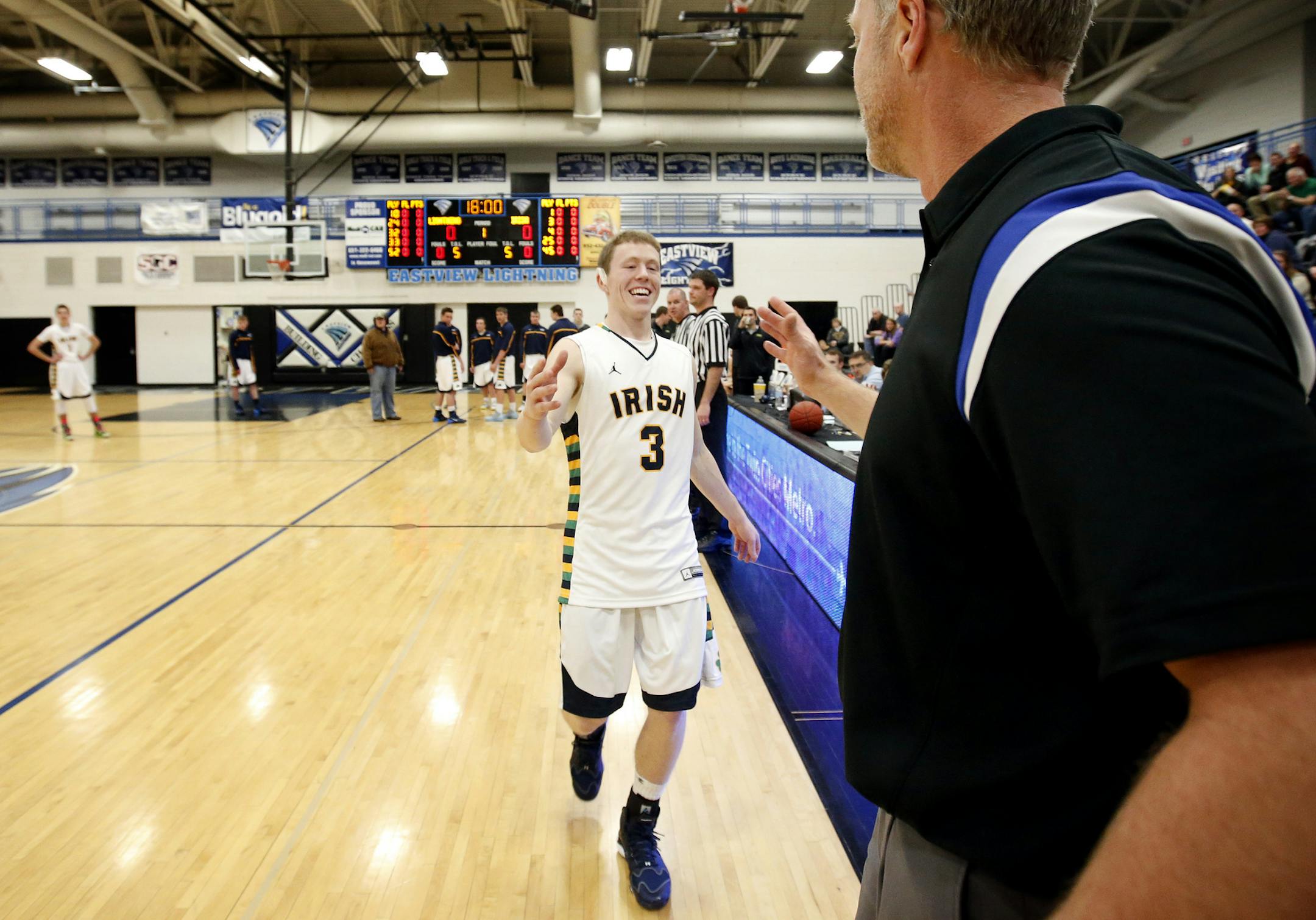 Eastview coach Paul Goetz got a handshake from his son Garrett, before the start of a game between Eastview vs. Rosemount. Goetz's son Garrett, plays for Rosemount. ] CARLOS GONZALEZ cgonzalez@startribune.com - January 7, 2013, Apple Valley, Minn., Eastview vs. Rosemount High School boys' basketball game, Eastview and Rosemount boys' basketball teams play at Eastview High School. It will be the first time Eastview coach Paul Goetz goes against his son, Garrett, at Rosemount