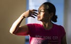 Maria Williams of Minneapolis is illuminated by the sun as she dances during practice.
