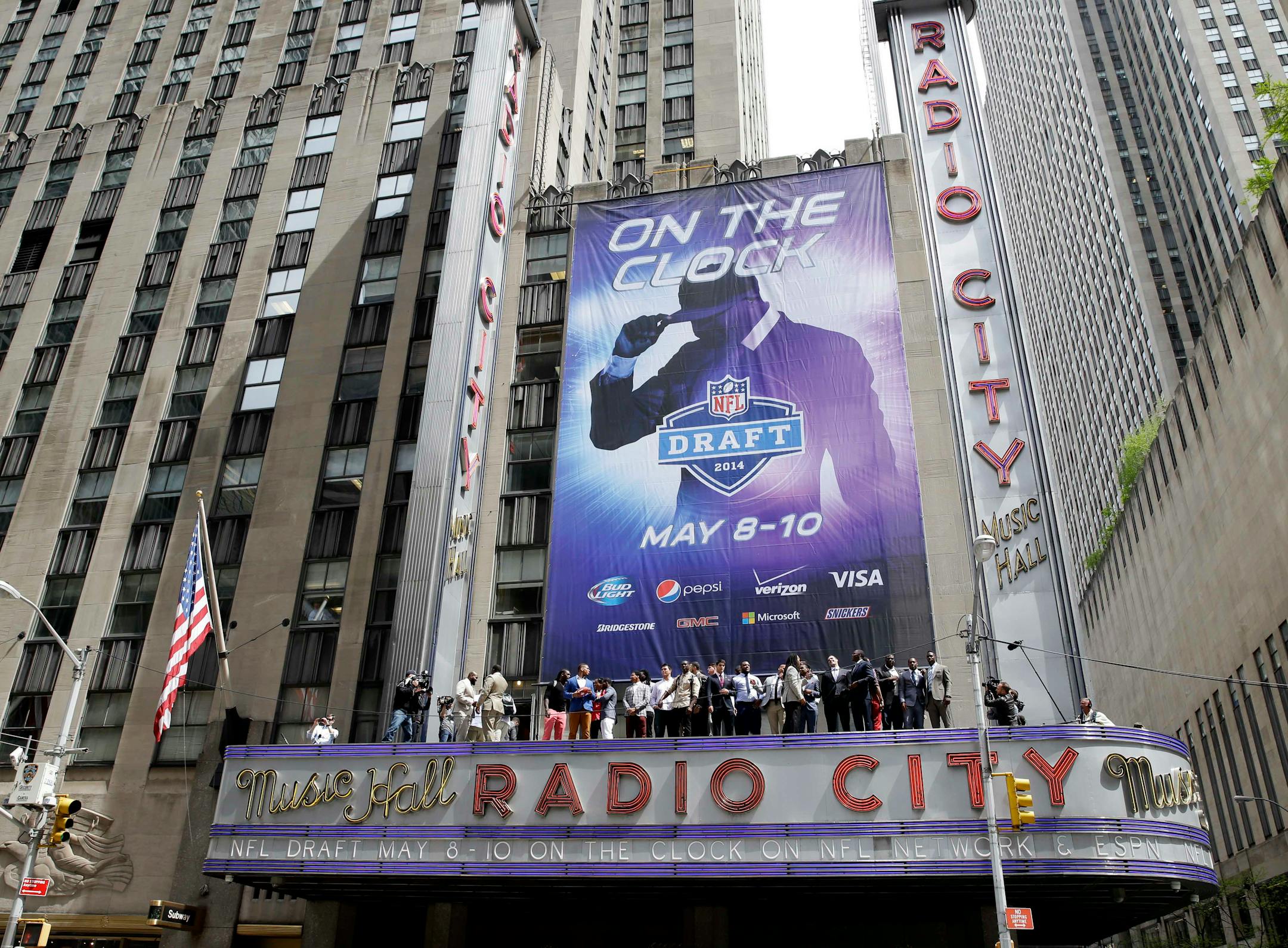 The 2014 NFL draft prospects line up on the awning of Radio City Music Hall for a photograph in New York, Wednesday, May 7, 2014. The draft, which takes place at Radio City Music Hall, will start on Thursday, May 8, 2014. (AP Photo/Seth Wenig)