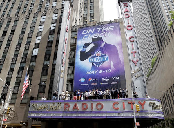 The 2014 NFL draft prospects line up on the awning of Radio City Music Hall for a photograph in New York, Wednesday, May 7, 2014. The draft, which tak