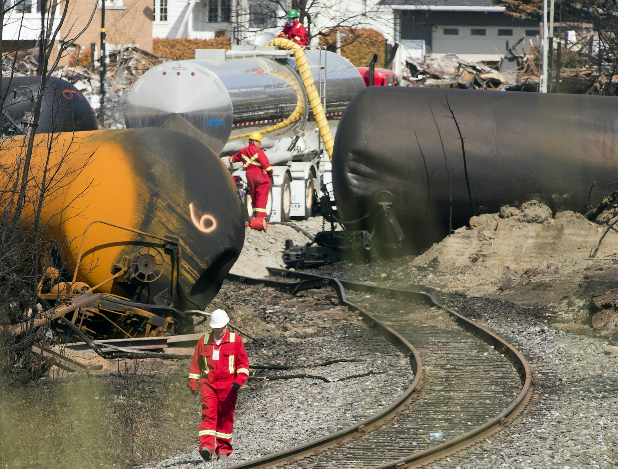 FILE - This July 6, 2013 file-pool photo shows work continuing at the crash site of the train derailment and fire in Lac-Megantic, Quebec. Federal inspection teams are headed to the booming Bakken oil region in Great Plains states to see if rail shipments of crude oil meet safety regulations. The inspections are dubbed the "Bakken blitz." U.S. officials announced them at a rail safety meeting Thursday. Inspections were prompted by last month's rail disaster in the lakeside Quebec town of Lac-Meg