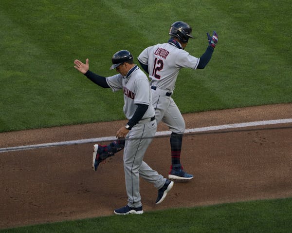 Cleveland Indians shortstop Francisco Lindor (12) celebrated his two run homer in the third inning with third base coach Mike Sarbaugh.