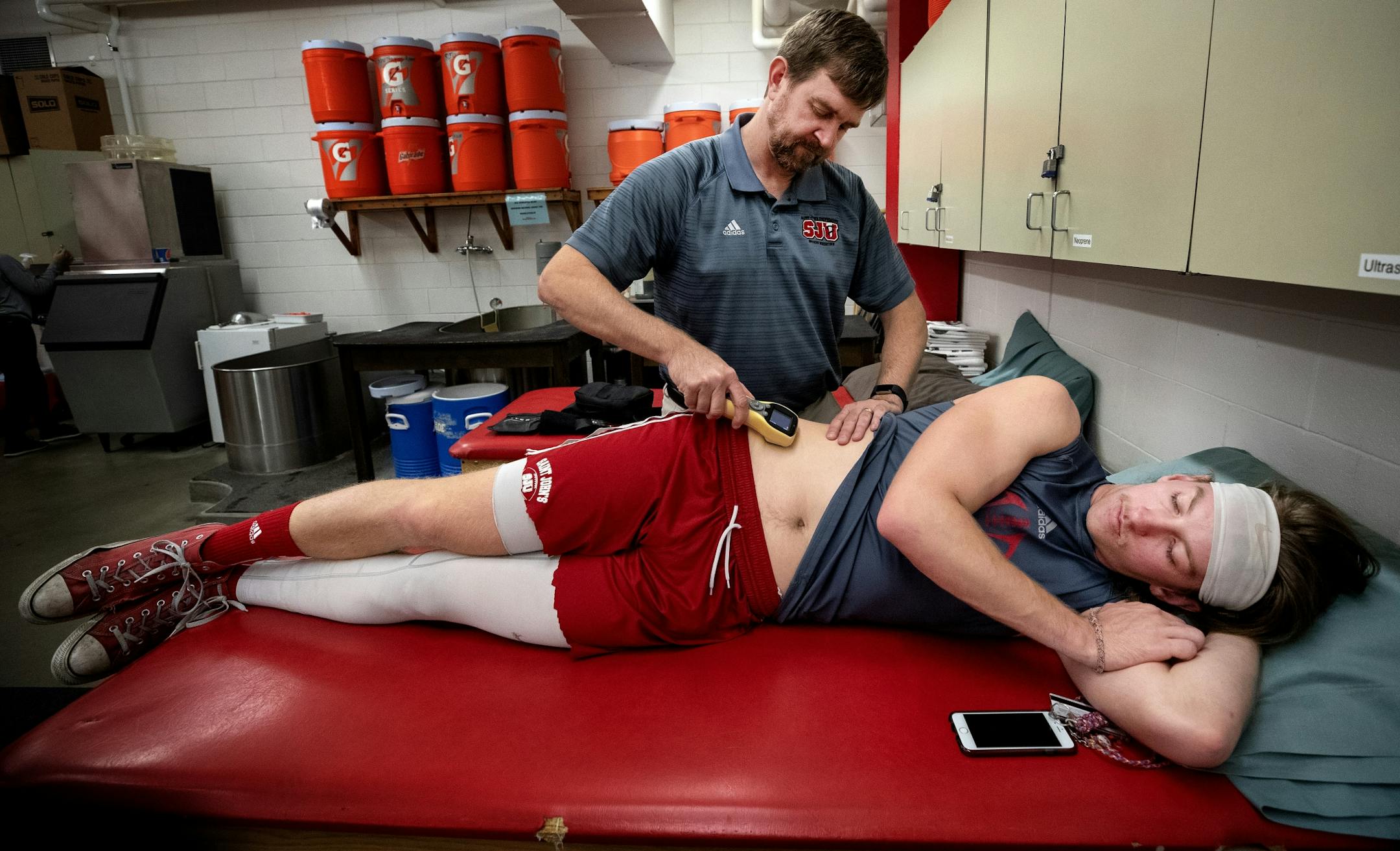 Jackson Erdmann was treated by head athletic trainer Scott Bierscheid before a practice.