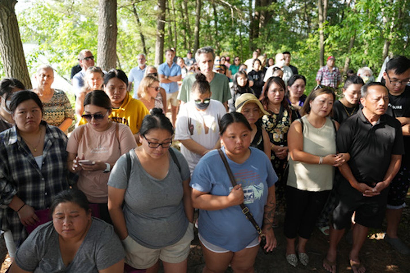 Community members stood during a vigil held by family of Yee Lee and Molly Cheng at the site where rescuers found the bodies of Cheng and their three children a week ago Saturday, July 9, 2022 at Vadnais Lake in Vadnais Heights, Minn. ] ANTHONY SOUFFLE • anthony.souffle@startribune.com