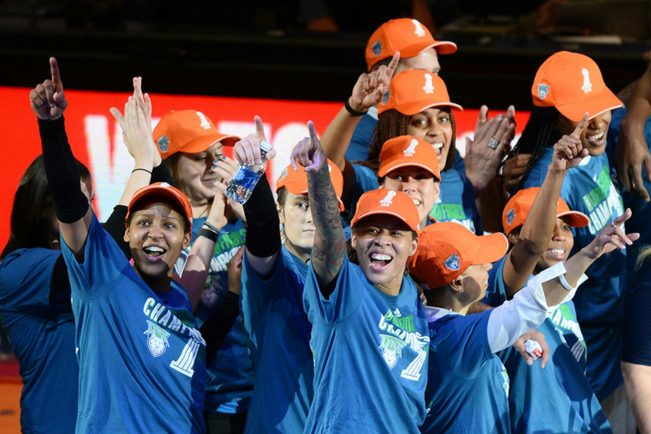 Minnesota Lynx forward Maya Moore (23), left, and guard Seimone Augustus (33) and teammates celebrated their championship victory Wednesday night against the Indiana Fever.