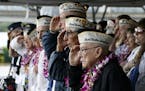 Pearl Harbor survivors salute during the National Anthem at a ceremony in Pearl Harbor, Hawaii on Friday, Dec. 7, 2018 marking the 77th anniversary of