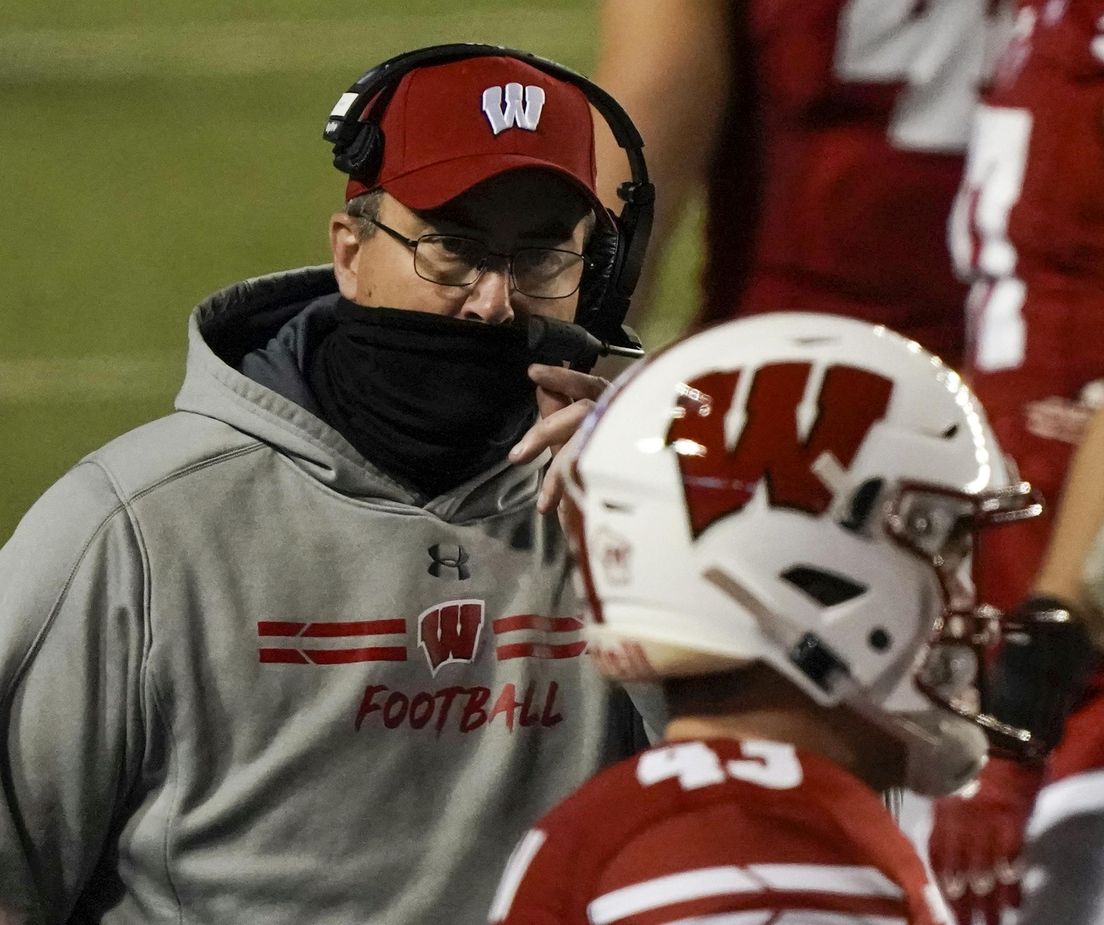 Wisconsin head coach Paul Chryst talks to players during the first half of an NCAA college football game against Illinois Friday, Oct. 23, 2020, in Madison, Wis. (AP Photo/Morry Gash) ORG XMIT: WIMG113