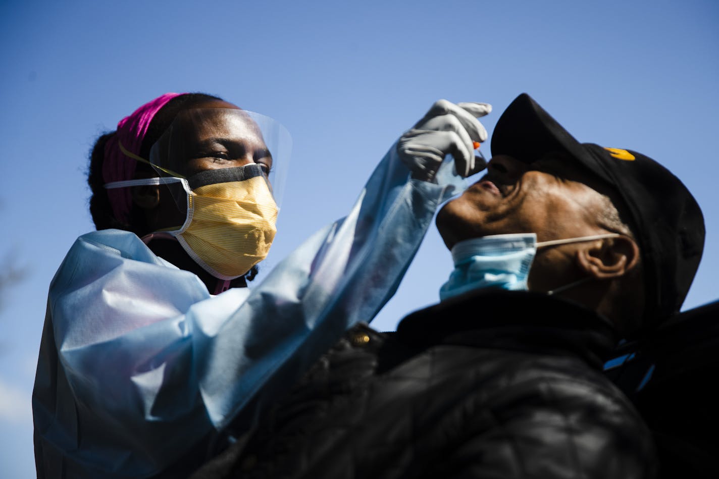 Dr. Ala Stanford administers a COVID-19 swab test on Wade Jeffries in the parking lot of Pinn Memorial Baptist Church in Philadelphia, Wednesday, April 22, 2020. Stanford and other doctors formed the Black Doctors COVID-19 Consortium to offer testing and help address heath disparities in the African American community. (AP Photo/Matt Rourke)