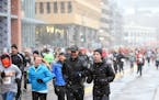 Light snow fell on runners in the 5k Turkey Day Run Thursday November 26, 2015 in Minneapolis.