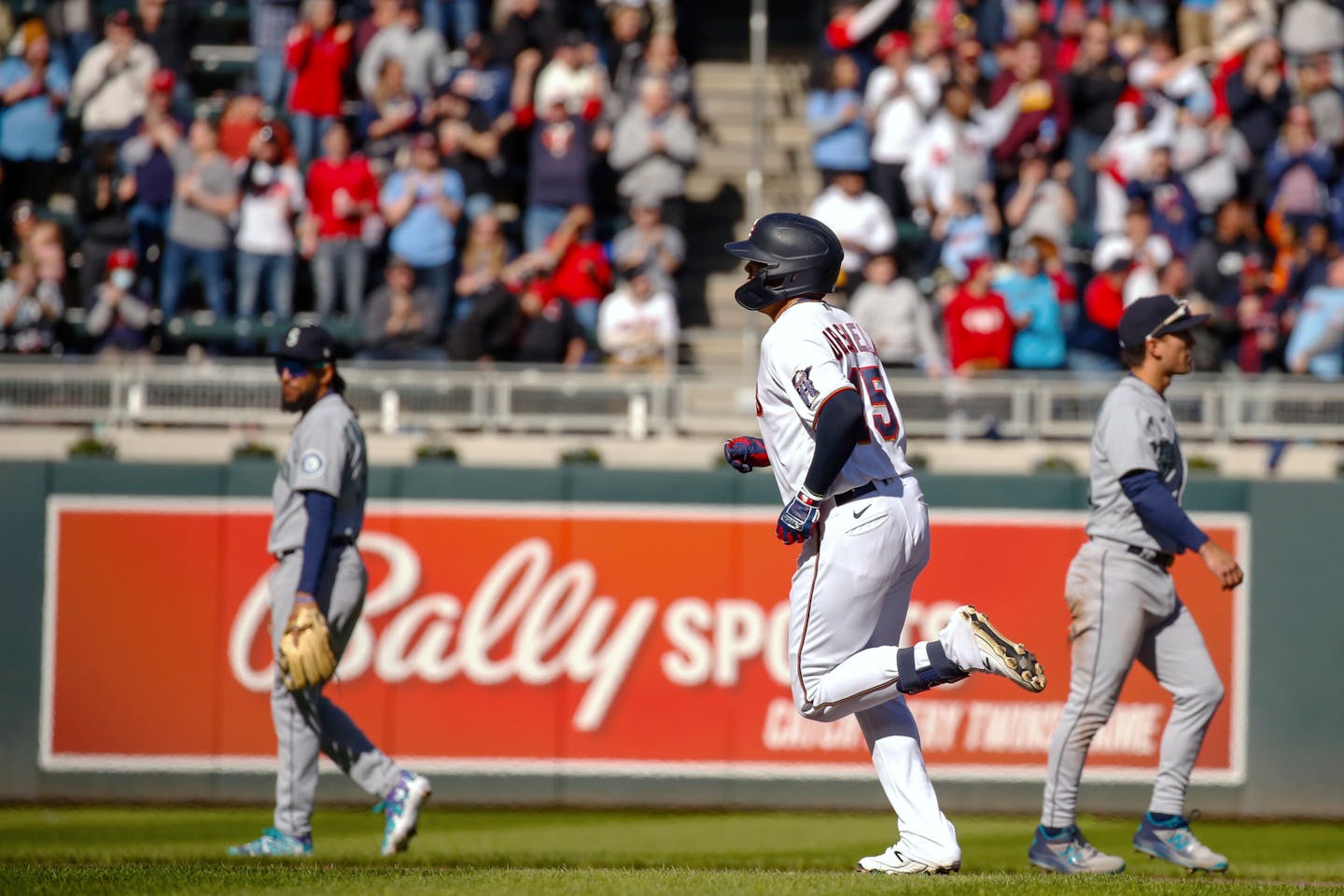 Minnesota Twins third baseman Gio Urshela (15) rounds the bases after hitting a home run in the fourth inning of a baseball game against the Seattle Mariners, Friday, April 8, 2022, in Minneapolis. (AP Photo/Nicole Neri)