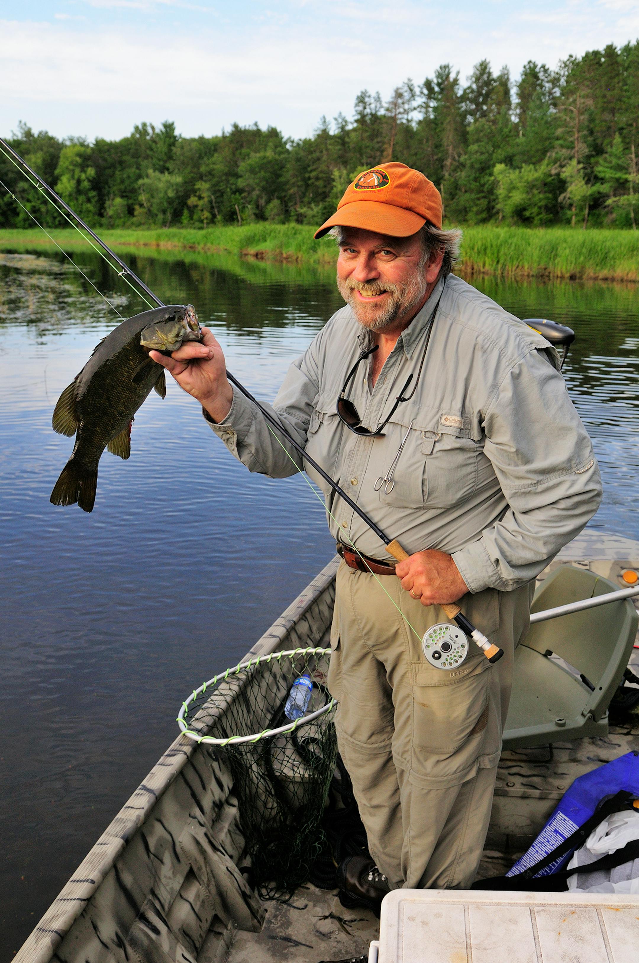 DO NOT USE. ONE-TIME USE WITH BILL MARCHEL COPY ONLY. Photo by Bill Marchel. Mickey Johnson, of Brainerd, displays a dandy smallmouth bass he caught while fly fishing an area river.