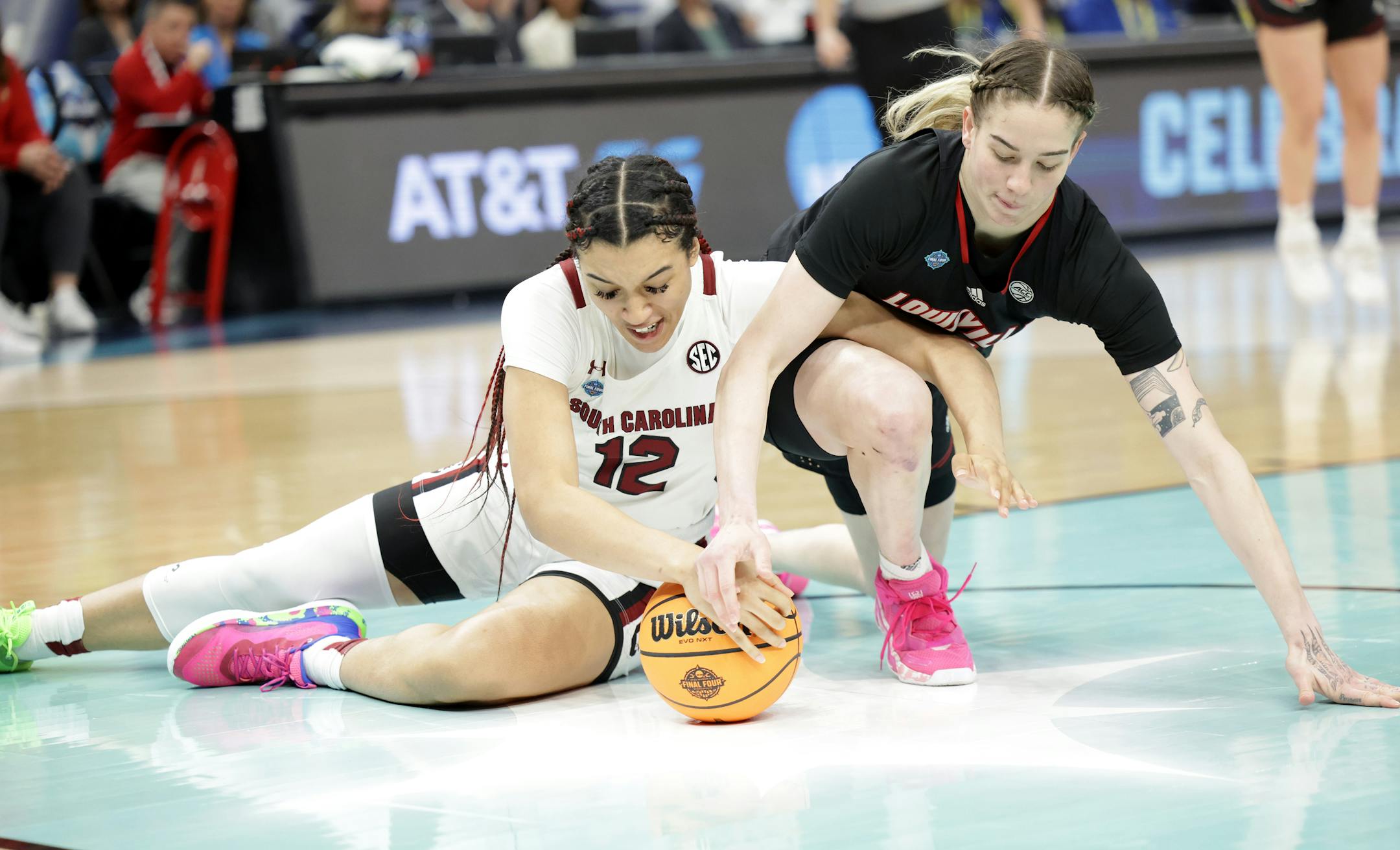 South Carolina guard Brea Beal and Louisville forward Emily Engstler fight for control of the ball.
