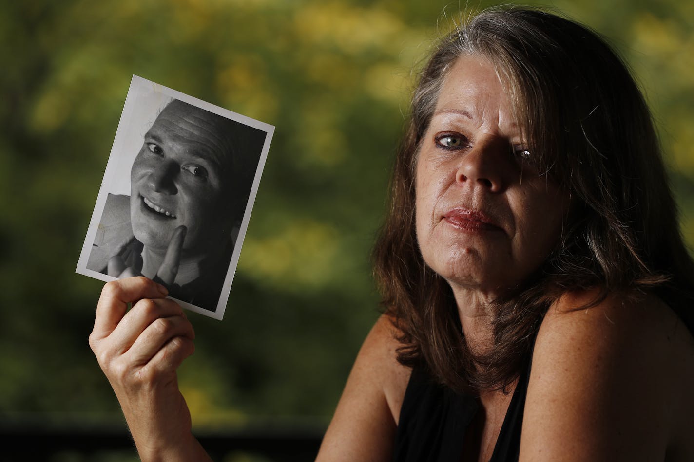 Barbara Behrend held a photo of her late husband, Joseph Behrend, who was killed in 1989.