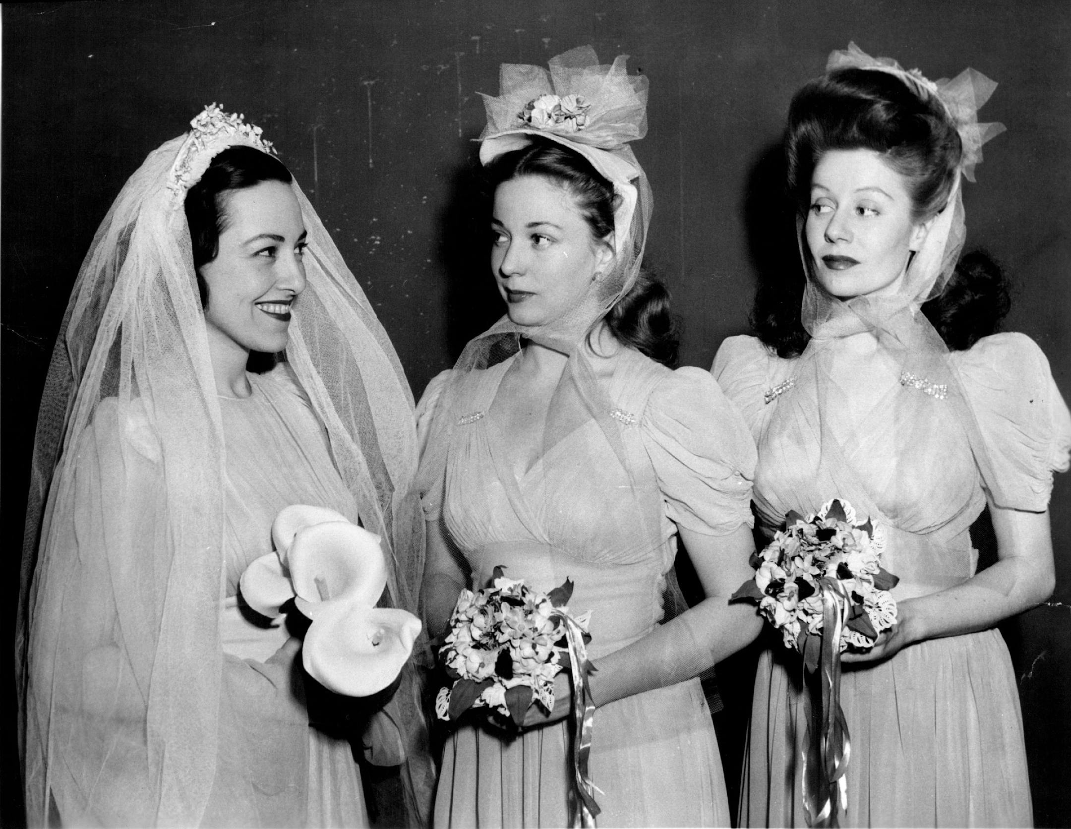 Black and white photo of a bride and two bridesmaids.