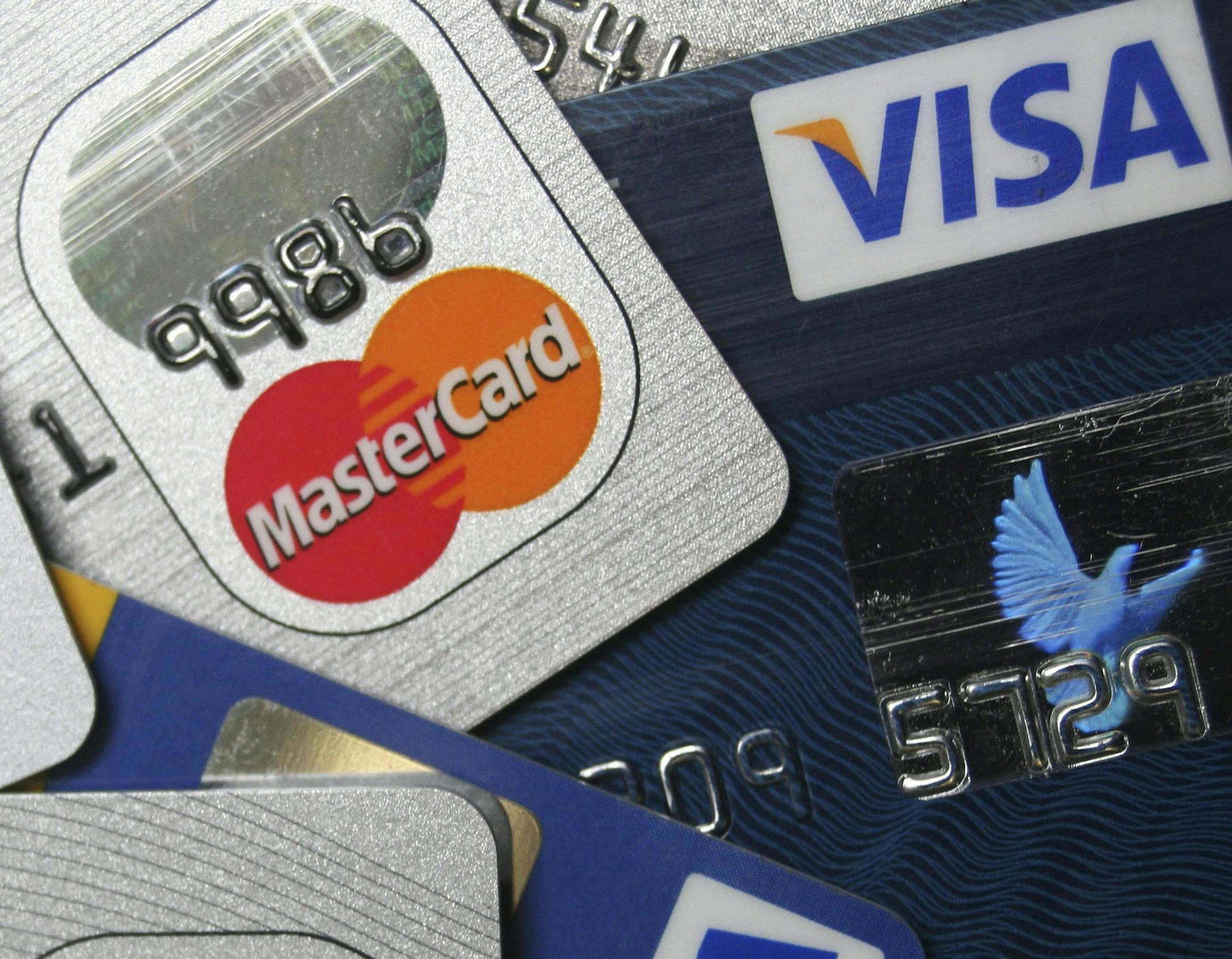 FILE - This file photo taken Nov. 18, 2009, a pile of MasterCard and VISA credit cards are displayed in Frankfurt, Germany. A sweater you buy for Christmas goes on sale for half price the next day. You might be able to get the difference back if you paid with a credit card.(AP Photo/Jochen Krause, File) ORG XMIT: MIN2012092017394113