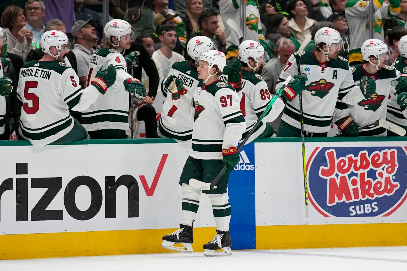 Minnesota Wild left wing Kirill Kaprizov (97) celebrates with the bench after socring against the Dallas Stars during the first period of Game 1 of an NHL hockey Stanley Cup first-round playoff series, Monday, April 17, 2023, in Dallas. (AP Photo/Tony Gutierrez) ORG XMIT: TXTG105