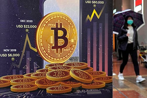 An advertisement for Bitcoin cryptocurrency is displayed on a street in Hong Kong