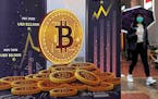 An advertisement for Bitcoin cryptocurrency is displayed on a street in Hong Kong