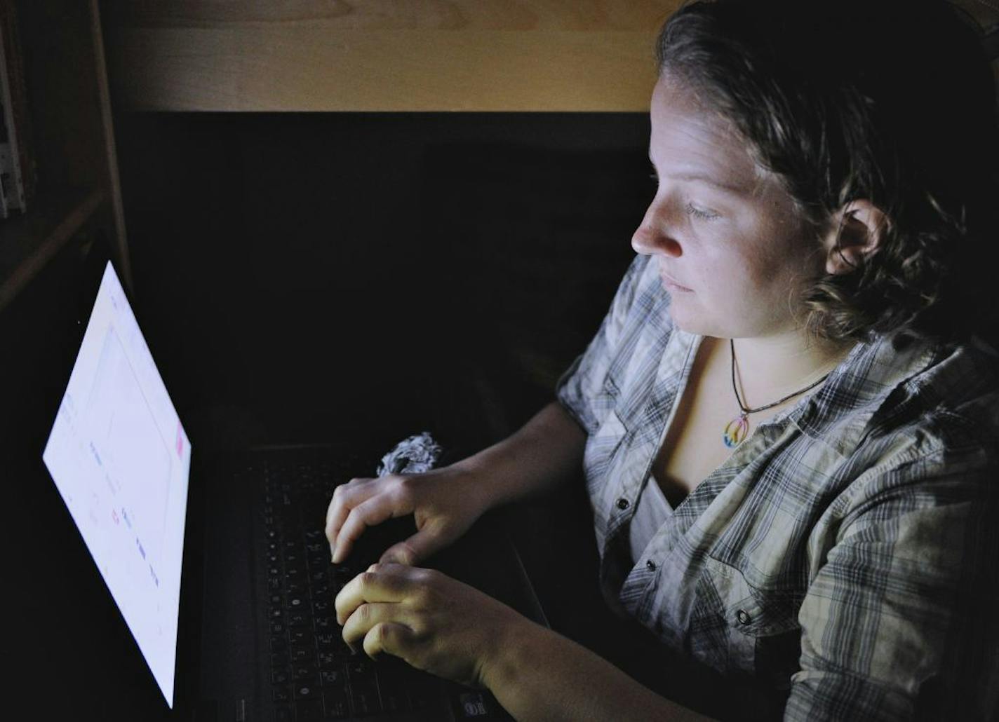 FILE - In this Monday, Sept. 26, 2011 file photo, 22-year-old Catherine Devine reads instant messages on her laptop screen at her home in Kings Park, N.Y. Devine had her first of several brushes with online harassment in seventh grade, before she'd even ventured onto the Internet. A report released Wednesday, Oct. 22, 2014 by the Pew Research Center found that nearly three-quarters of American adults who use the Internet have witnessed online harassment. Forty percent have experienced it themsel