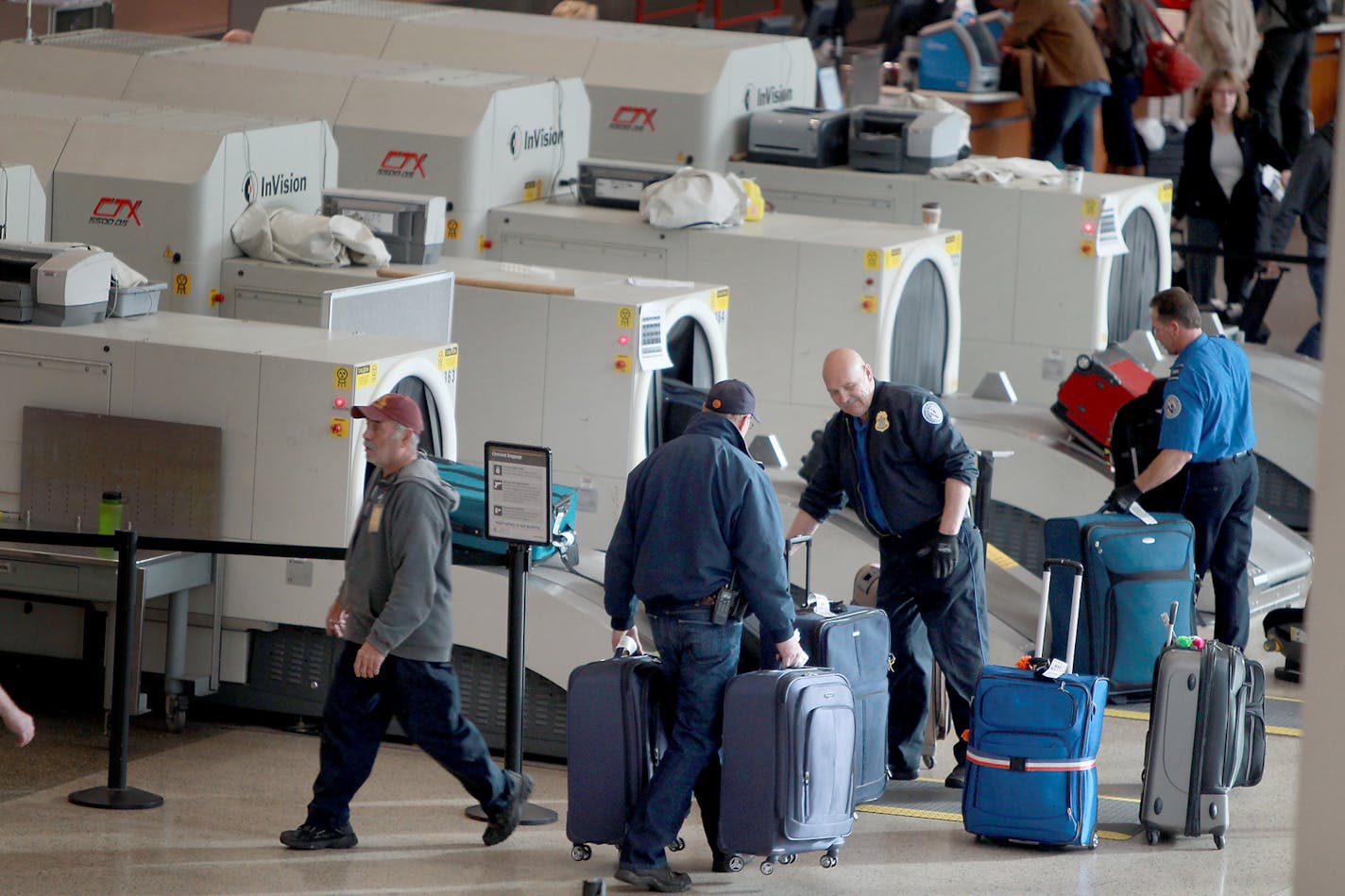 Security checked incoming baggage as travelers squeezed their way back into the ticketing and security lines at the Humphrey terminal after a security alert early Friday, April 27, 2012 in Bloomington, MN. (ELIZABETH FLORES/STAR TRIBUNE) ELIZABETH FLORES &#xa5; eflores@startribune.com ORG XMIT: MER567dcb3be43faa2aff9f0c1797d3d