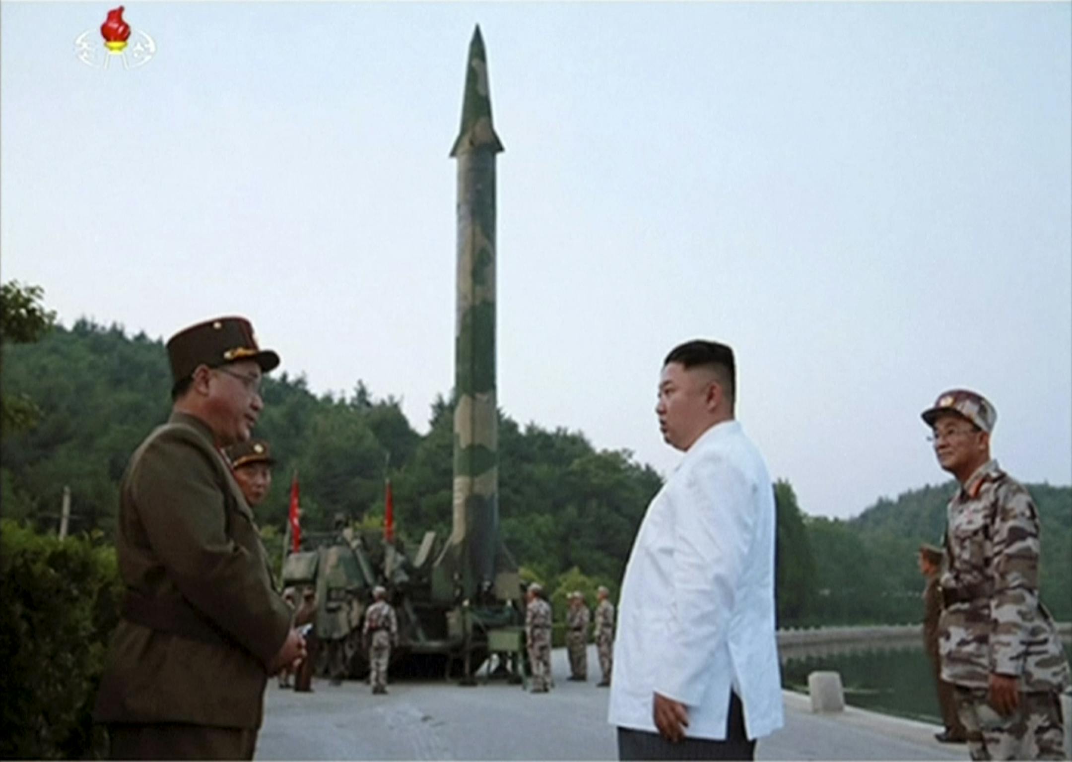 This image made from video of an undated still image broadcasted in a news bulletin on Tuesday, May 30, 2017, by North Korea's KRT shows North Korean leader Kim Jong Un and a missile launcher in North Korea. North Korean state television (KRT) aired on Tuesday video of Kim apparently giving field guidance at the test fire of a Scud-type ballistic missile, which reportedly took place the previous day. Independent journalists were not given access to cover the event depicted in this photo. (KRT vi