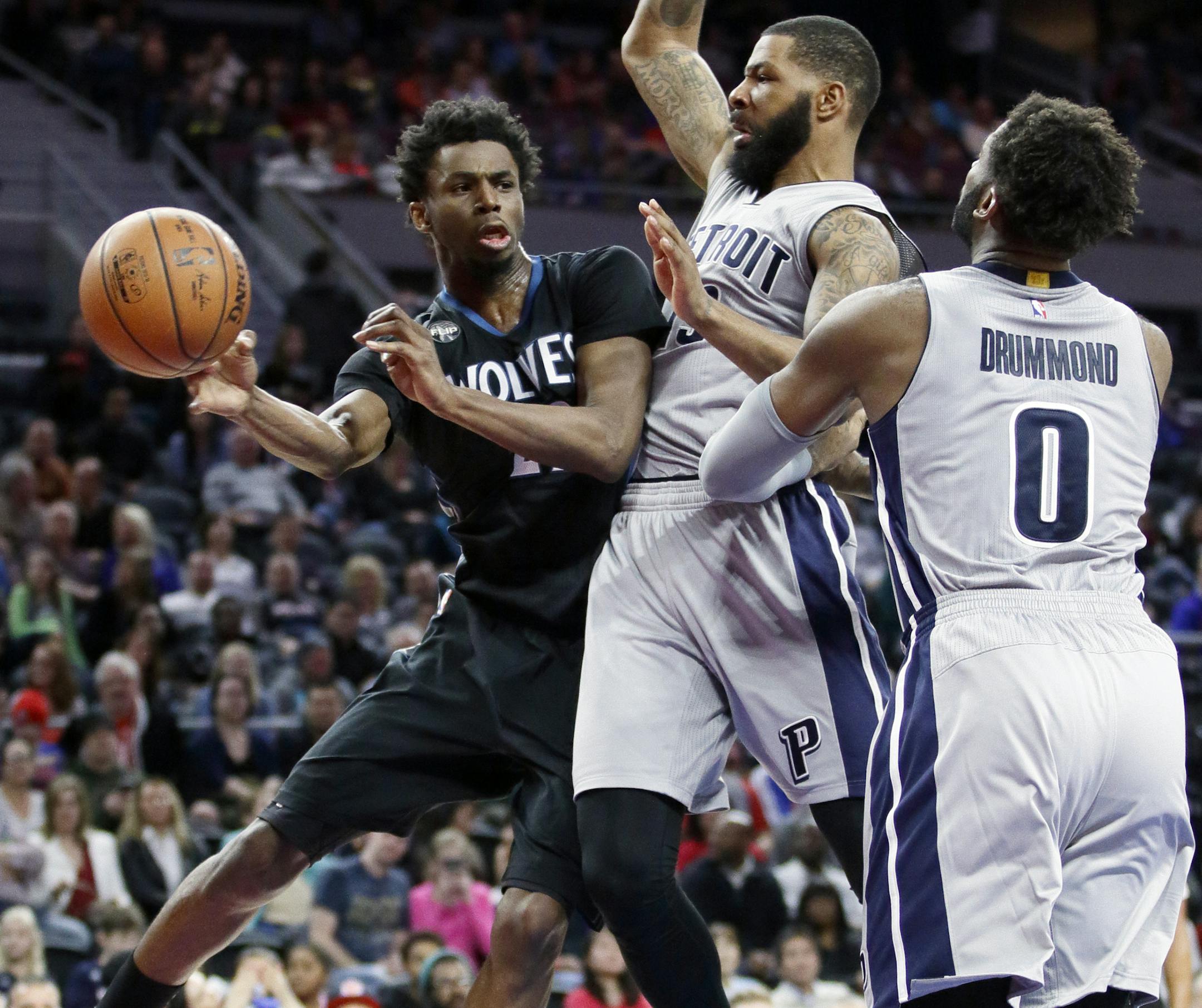 Minnesota Timberwolves&#x2019; Andrew Wiggins, left, passes the ball against Detroit Pistons defenders Marcus Morris, center, and Andre Drummond (0) during the second half of an NBA basketball game Thursday, Dec. 31, 2015, in Auburn Hills, Mich. The Pistons defeated the Timberwolves 115-90. (AP Photo/Duane Burleson)