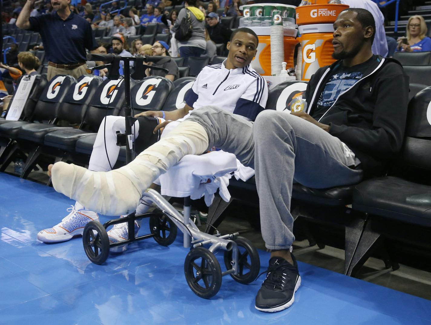 Oklahoma City Thunder guard Russell Westbrook, left, talks with teammate Kevin Durant before the Thunder's preseason NBA basketball game against the Utah Jazz in Oklahoma City, Tuesday, Oct. 21, 2014. (AP Photo/Sue Ogrocki)