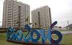 The Rio 2016 sign stands in front of the Olympic Village during a media tour in Rio de Janeiro, Brazil, Thursday, June 23, 2016. The organizers of the