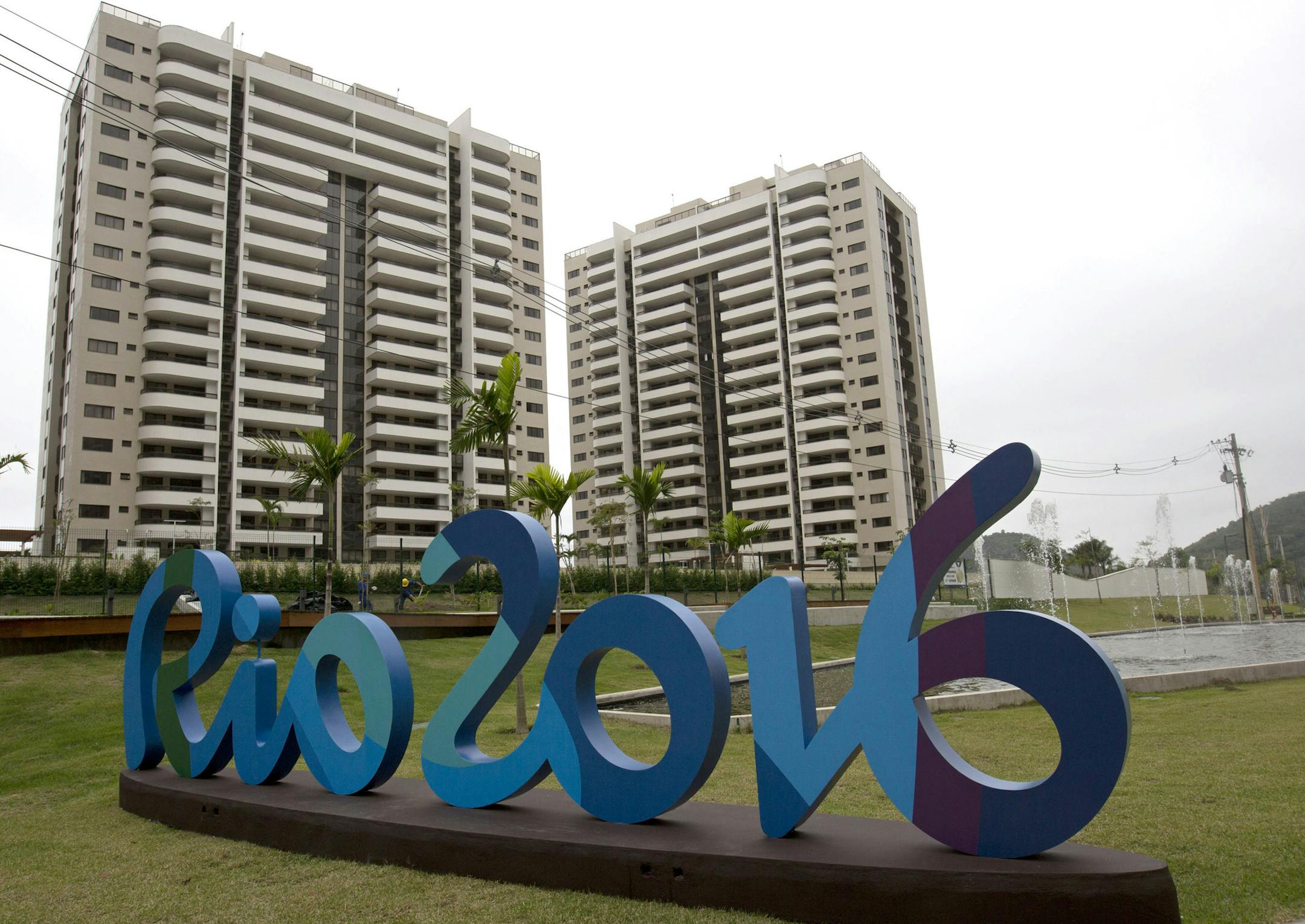 The Rio 2016 sign stands in front of the Olympic Village during a media tour in Rio de Janeiro, Brazil, Thursday, June 23, 2016. The organizers of the Rio de Janeiro Olympics have unveiled the athletes' village, where nearly 11,000 competitors and some 6,000 coaches and other team members will stay during the Aug. 5-21 games. (AP Photo/Silvia Izquierdo)