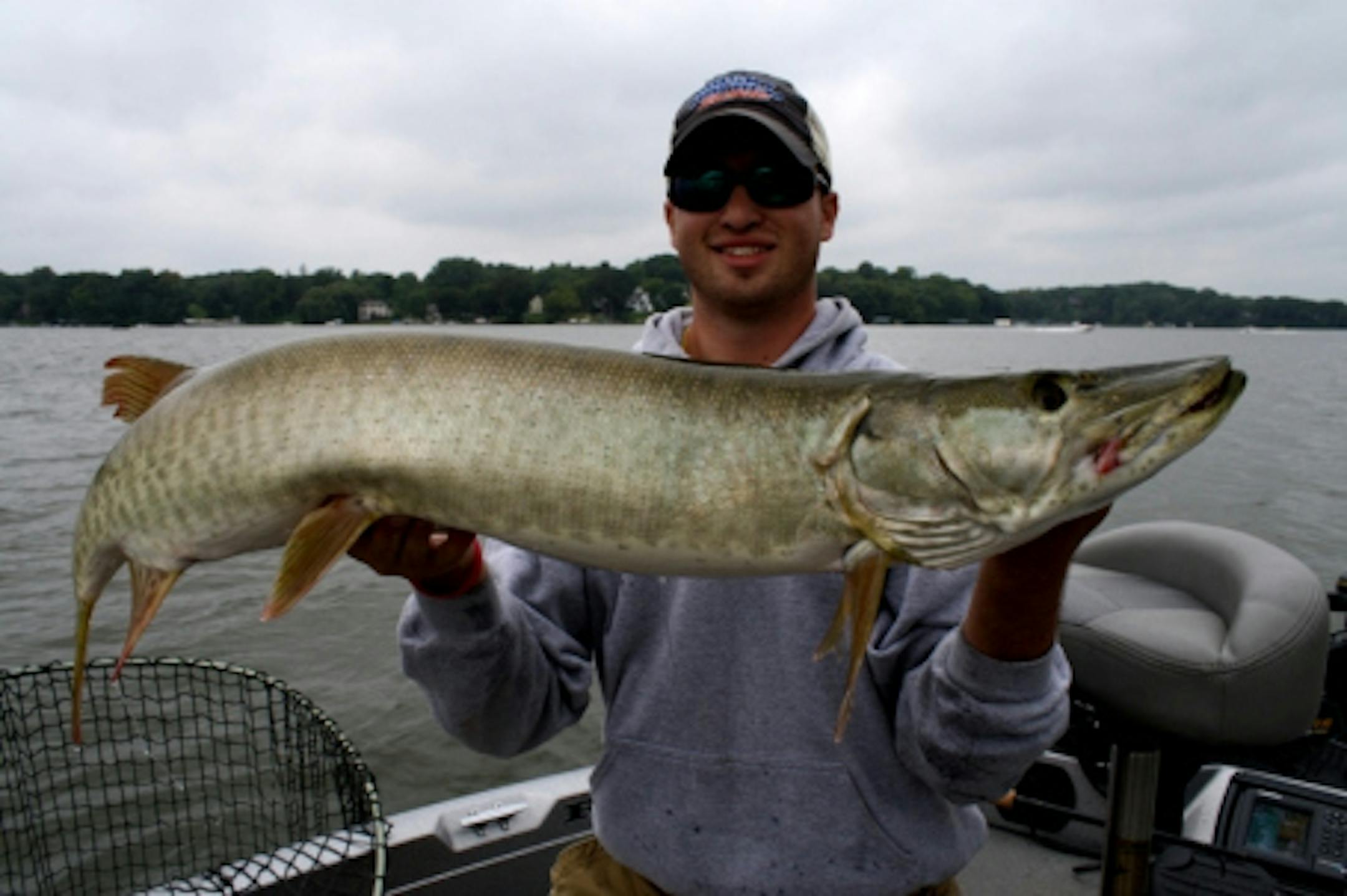Eric Wolf proudly hoists his 2nd muskie of the day!