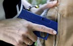 FILE - In this Aug. 29, 2016 file photo, Marilyn Smolenski uses a mock gun to demonstrate how to pull a handgun out of concealed carry clothing she de