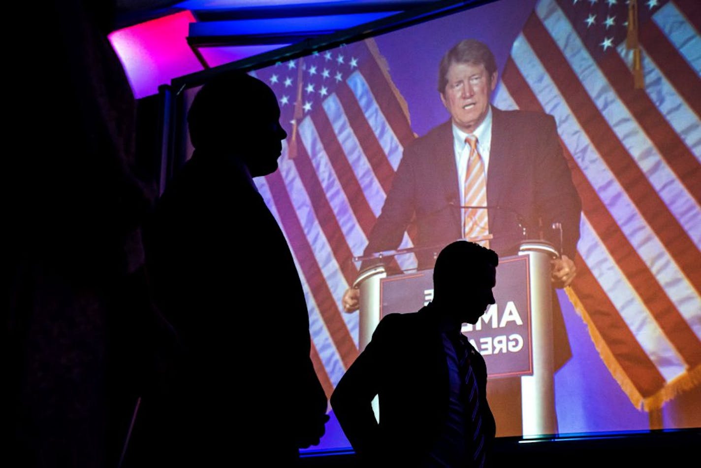 Congressional candidates Kendall Qualls and Tyler Kistner listened backstage as Jason Lewis spoke to the crowd at the election night party at the DoubleTree Hotel in Bloomington.