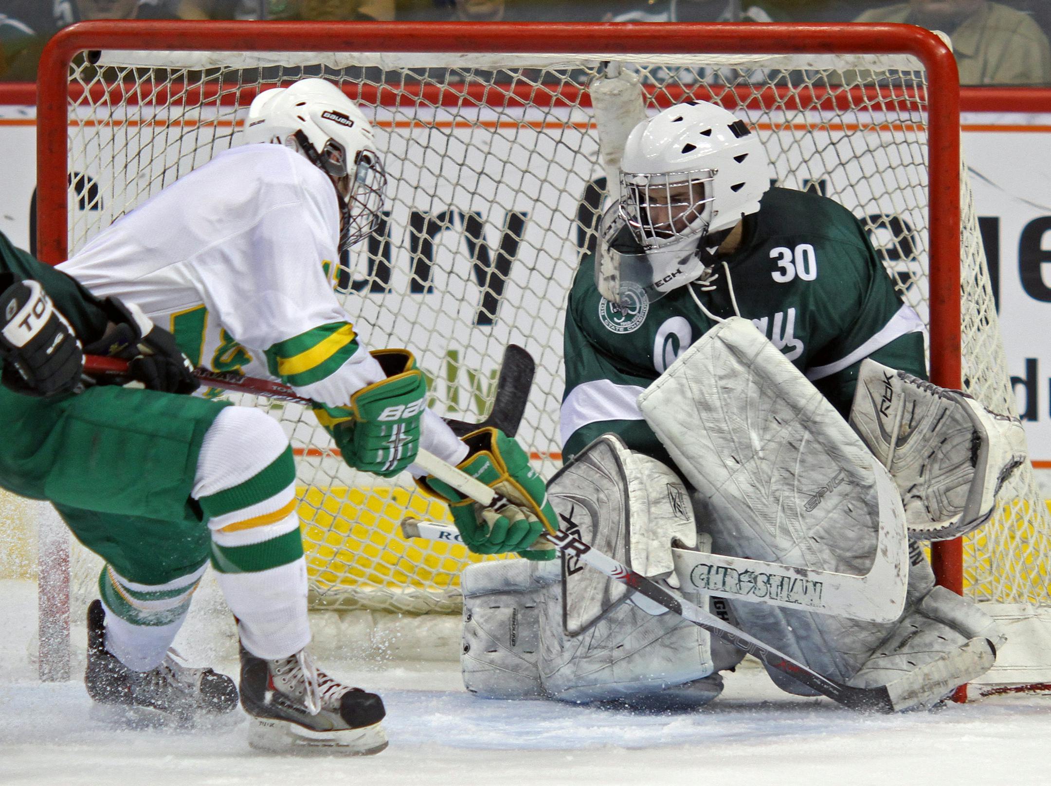 File -- Edina's Michael Sit looked for the rebound as Charlie Taft scored the seventh Hornet goal past Roseau goalie Ethan Kvidt.