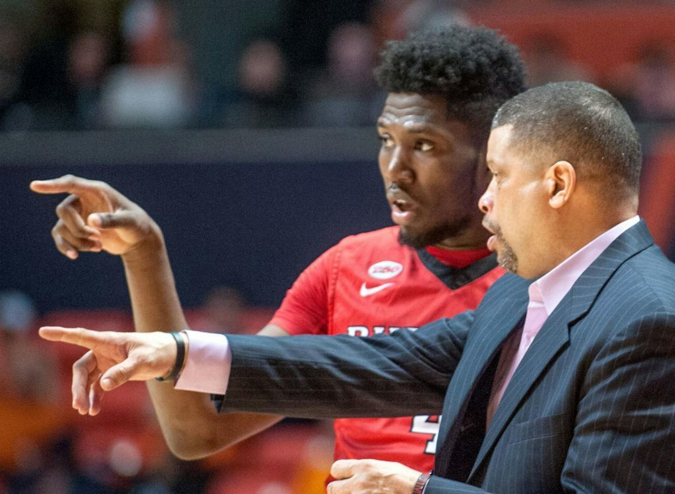 Rutgers head coach, Eddie Jordan talks with Rutgers' forward Jonathan Laurent (4) on the sidelines in the second half of the NCAA college basketball game at State Farm Center in Champaign, Ill on Tuesday, Feb. 16, 2016. Illinois won 82-66.