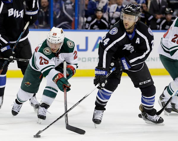 Tampa Bay Lightning right wing Ryan Callahan (24) steals a pass intended for Minnesota Wild right wing Jason Pominville (29) during the first period o