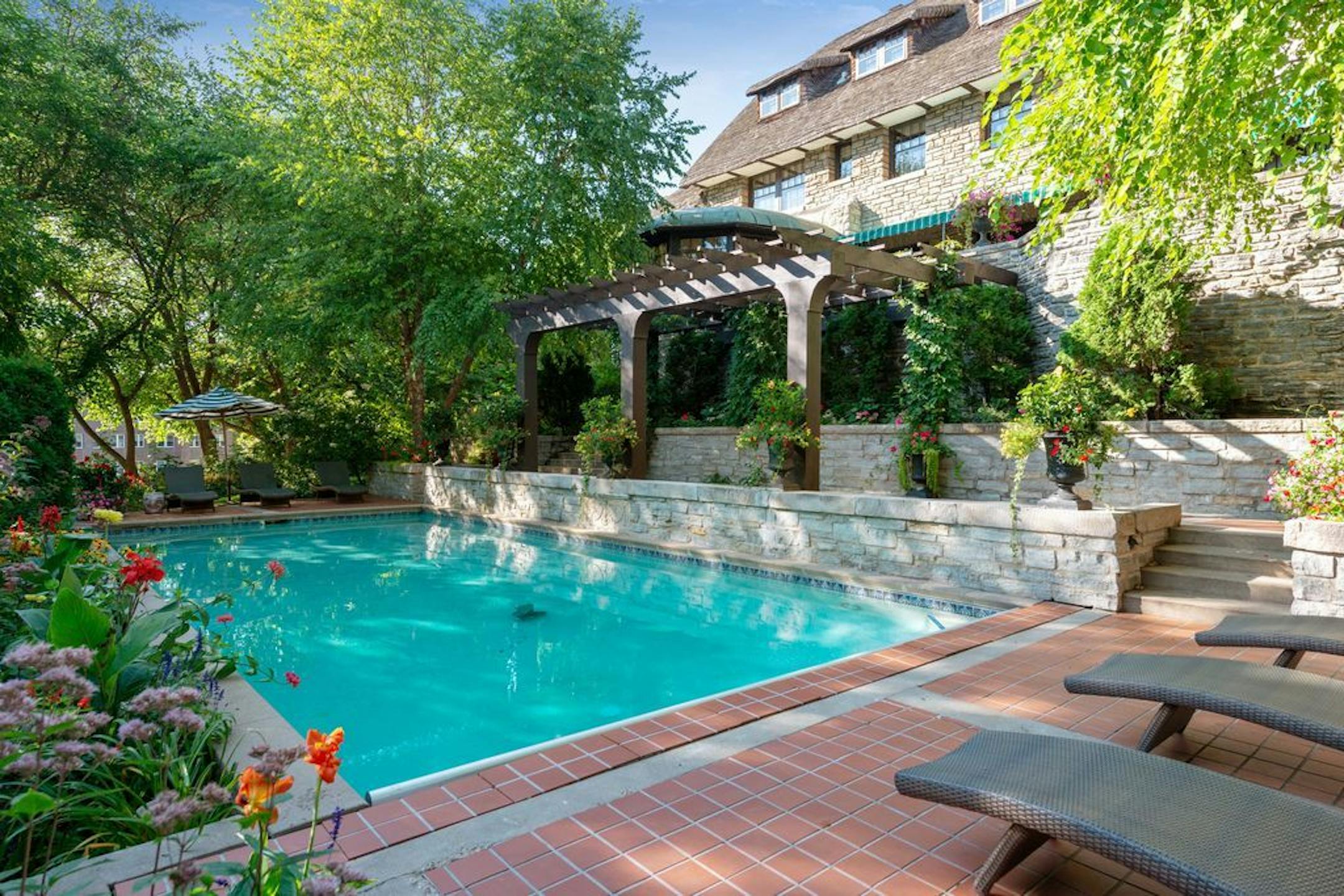 Because the home is on the National Register of Historic Places, the pool had to be built with period-appropriate materials, including vintage-look tile and stone retaining walls.