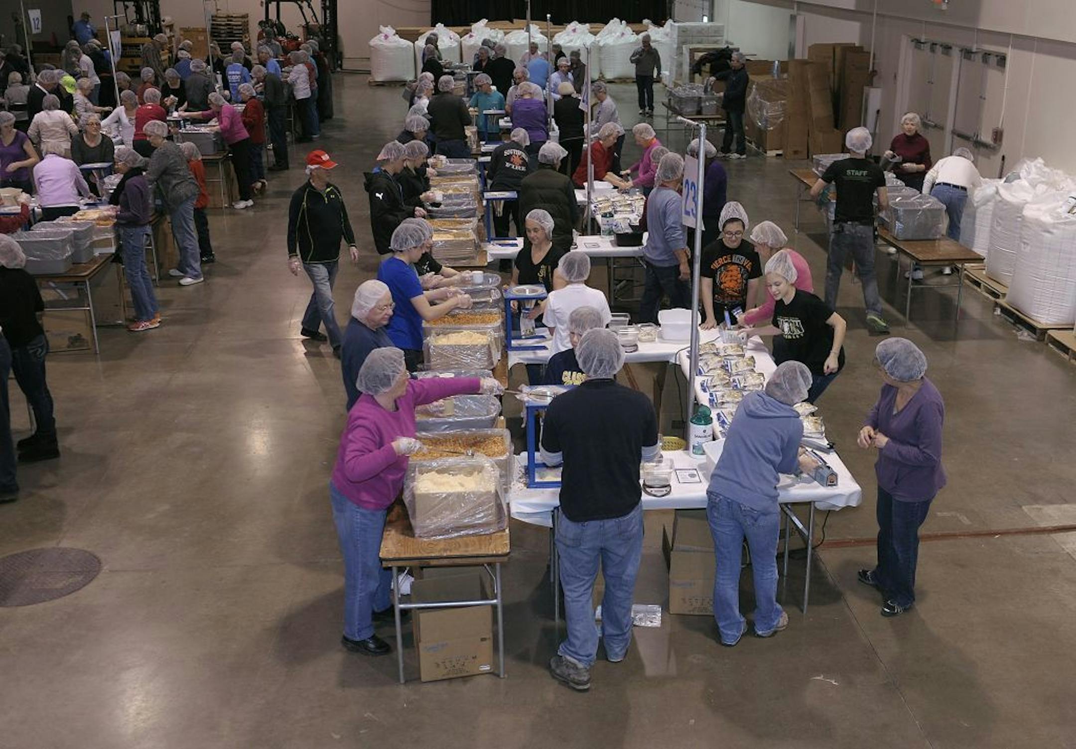 In this Feb. 14, 2014 photo, volunteers pack food for the malnourished during the 2 Million Meals event, in Novi, Mich.