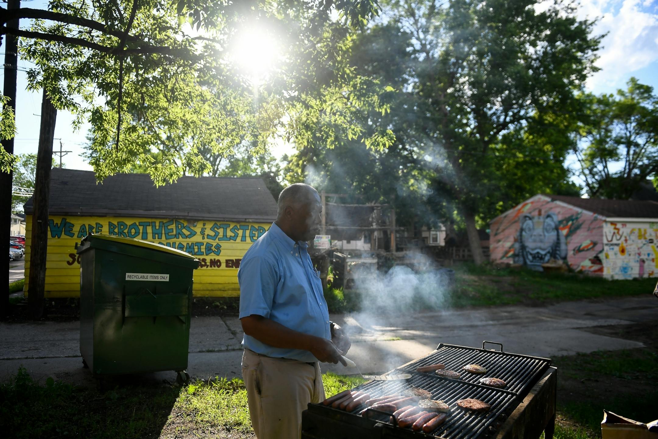 Redeemer Lutheran Church Rev. Kelly Chatman cooked brats and burgers before the start of Wednesday night's community cookout. .
