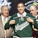 Matthew Dumba, center, a defenseman, smiles with officials from the Wild after being chosen seventh overall in the first round of the 2012 NHL draft.
