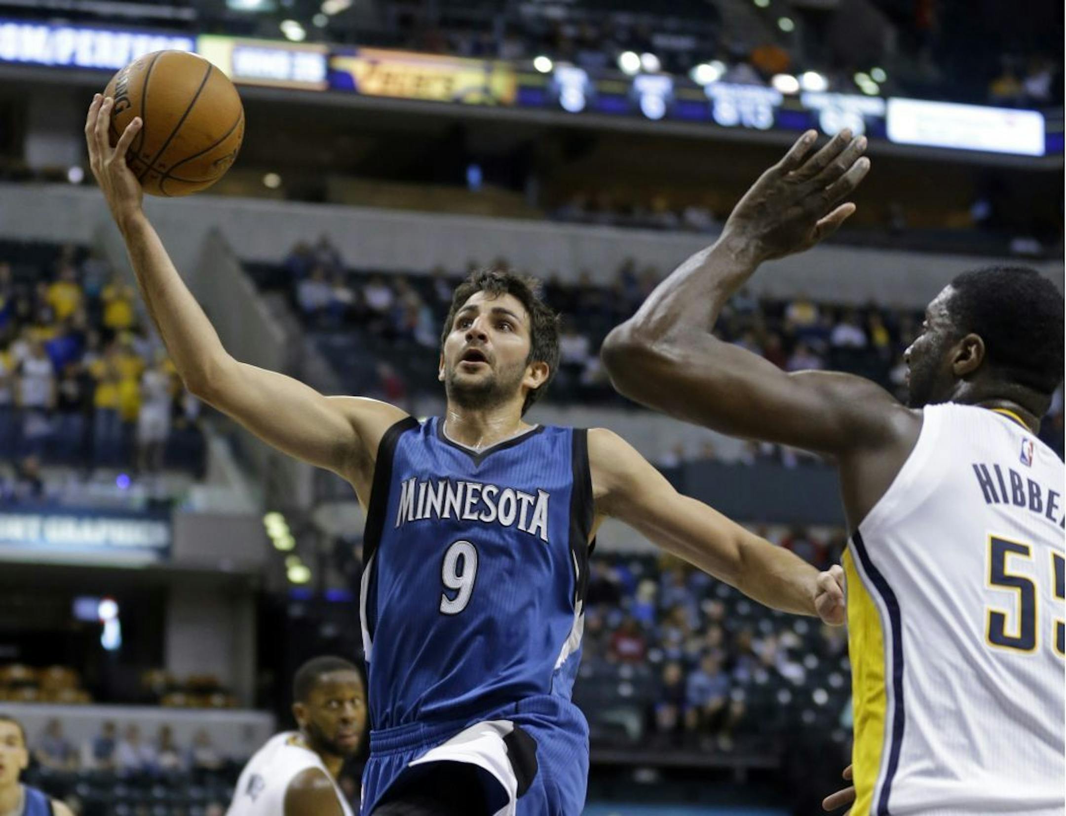 Wolves guard Ricky Rubio, left, shot over Pacers center Roy Hibbert during the first half in Indianapolis on Tuesday. Indiana beat Minnesota 103-90 in the teams' preseason opener.