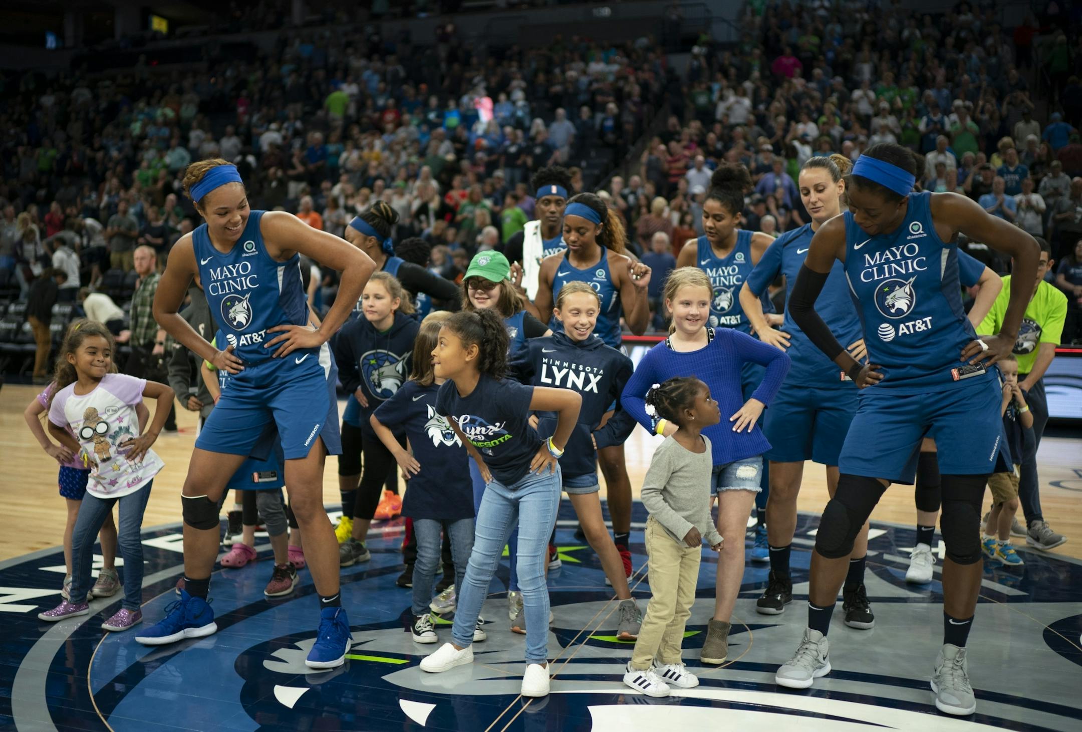 The Lynx players, including forward Napheesa Collier (24), left, and center Temi Fagbenle (14), right, did their traditional post-game victory dance with young fans after their last home game of the regular season.
