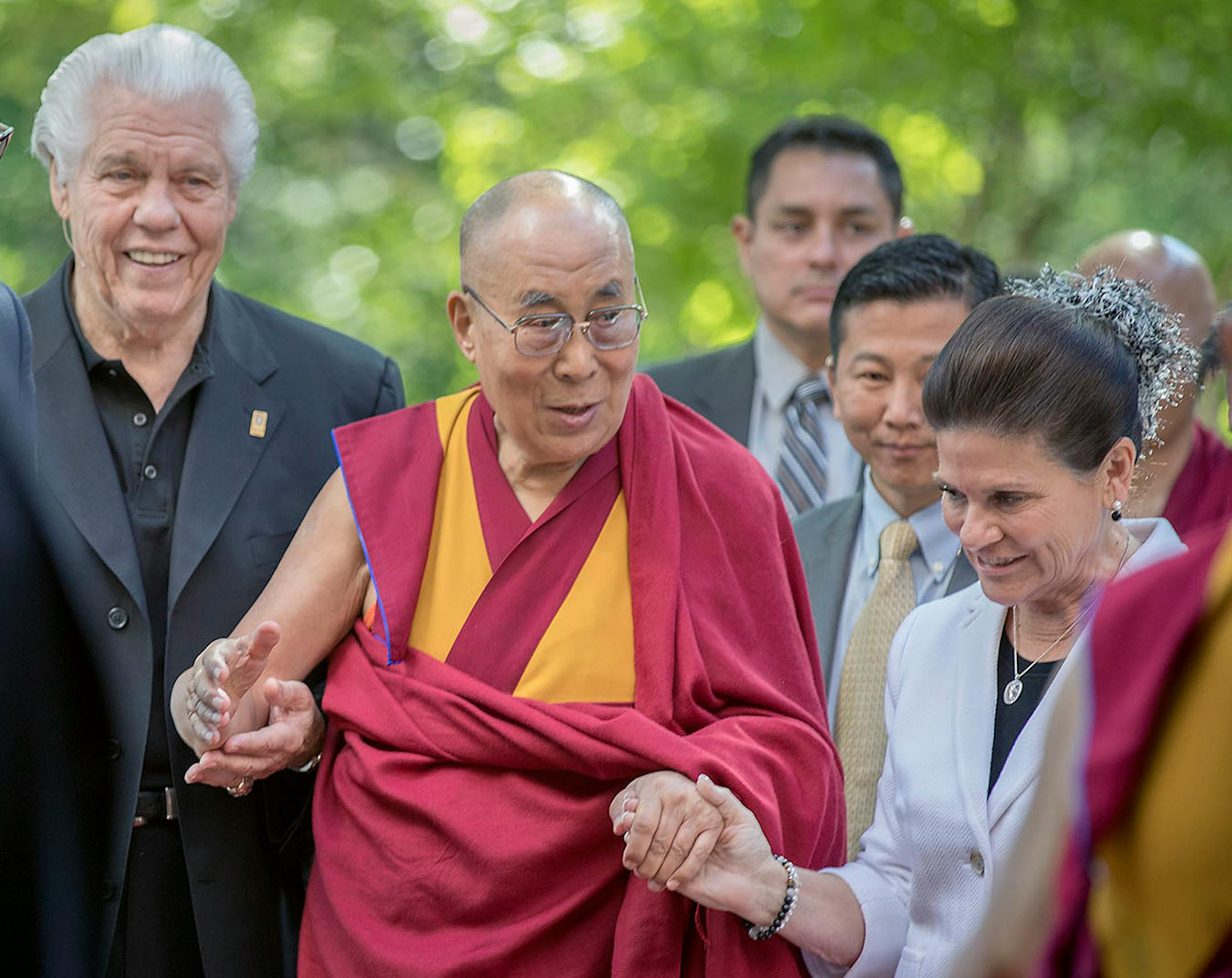 The Dalai Lama was welcomed to Minnesota by Starkey Hearing Technologies Owner, CEO, and President Bill Austin, left, and his wife Tani Austin, chief philanthropy officer of Starkey Hearing Technologies, right, before they participated in a panel discussion at Starkey Hearing Technologies, Friday, June 23, 2017 in Eden Prairie, MN.