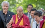 The Dalai Lama was welcomed to Minnesota by Starkey Hearing Technologies Owner, CEO, and President Bill Austin, left, and his wife Tani Austin, chief 