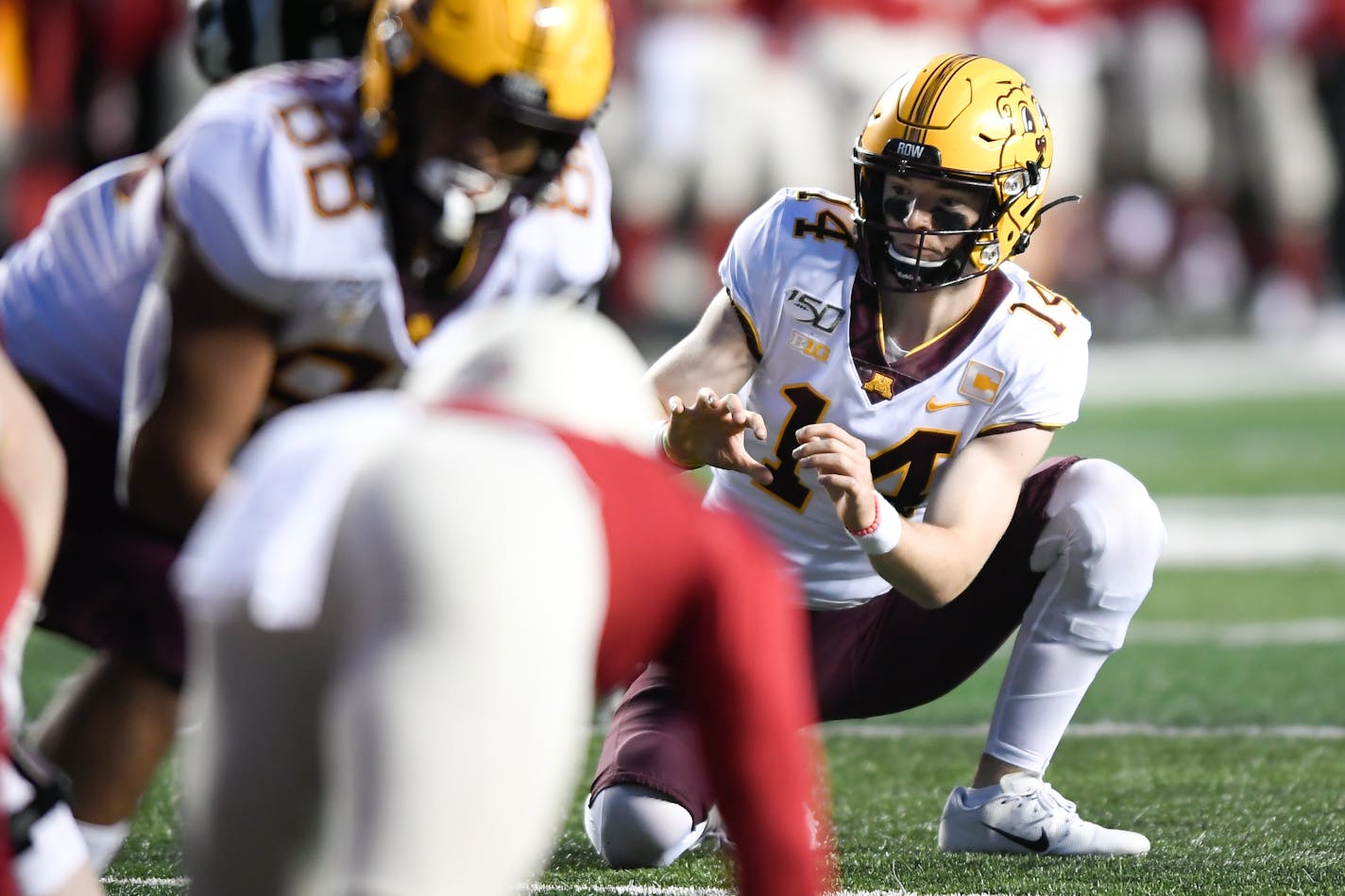 Gophers holder Casey O'Brien set up for an extra point during a game in 2019.