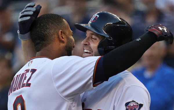 Eduardo Nunez(9) hit an inside the park HR in the first inning gets greeted by Brian Dozier(2).] At Target Field in a game between the Tampa Bay Rays 