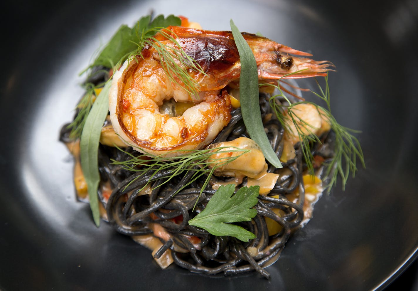 Spaghetti Nero with prawns, mussels, octopus, fra diavolo and fines herbes at Spoon and Stable. ] CARLOS GONZALEZ cgonzalez@startribune.com, March 24, 2015, Minneapolis, Minn., Restaurant review: Spoon and Stable, chef/owner Gavin Kaysen