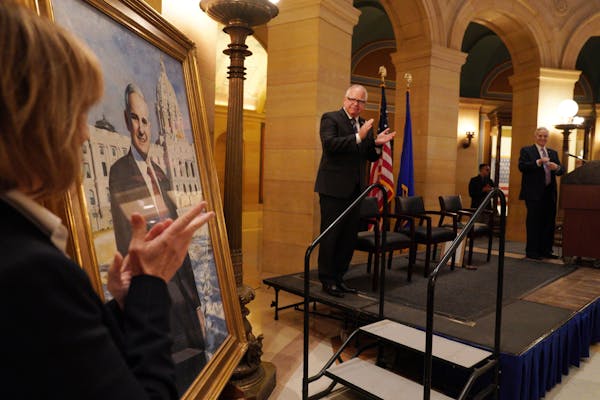 Sen. Tina Smith and Gov. Tim Walz applauded as former Gov. Mark Dayton's official Capitol portrait was unveiled during a ceremony Thursday.