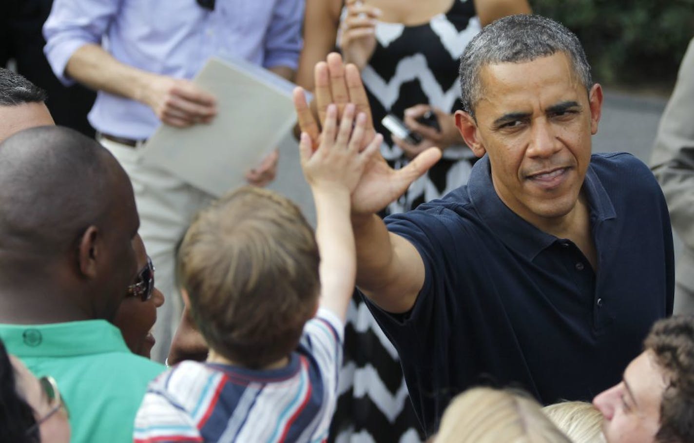 President Barack Obama visits with service members while hosting an Independence Day celebration Wednesday, July 4, 2012, on the South Lawn of the White House in Washington.