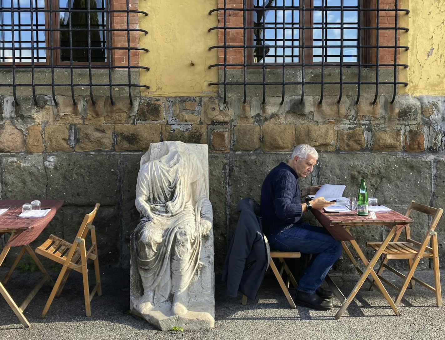 An ancient Roman marble statue sat among tables of a restaurant in Rome, where travelers may be able to return soon without quarantining.